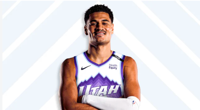 Josh Green poses in a Utah Jazz jersey with his arms crossed